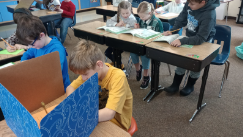Image of students working in Mrs. Stultz's classroom. Faces are covered to protect privacy. 